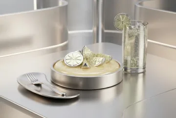Chrome citrus tart with metallic lime slices beside a sparkling lime soda in a reflective futuristic 3D table setting.