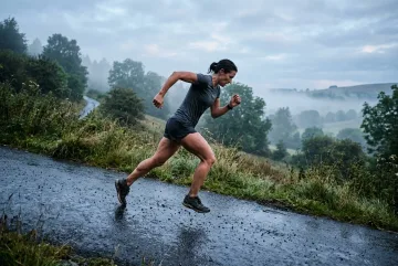 Athlete performing a steep hill sprint on a wet park path at misty dawn in Fine Art Photography.